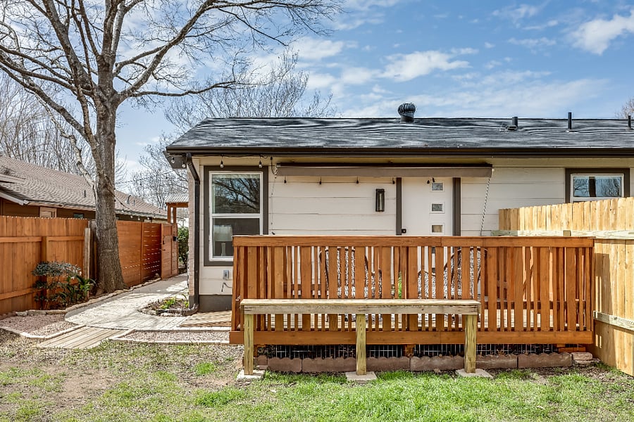 Spacious exterior deck with entry ramp, lounge furniture, and retractable awning.