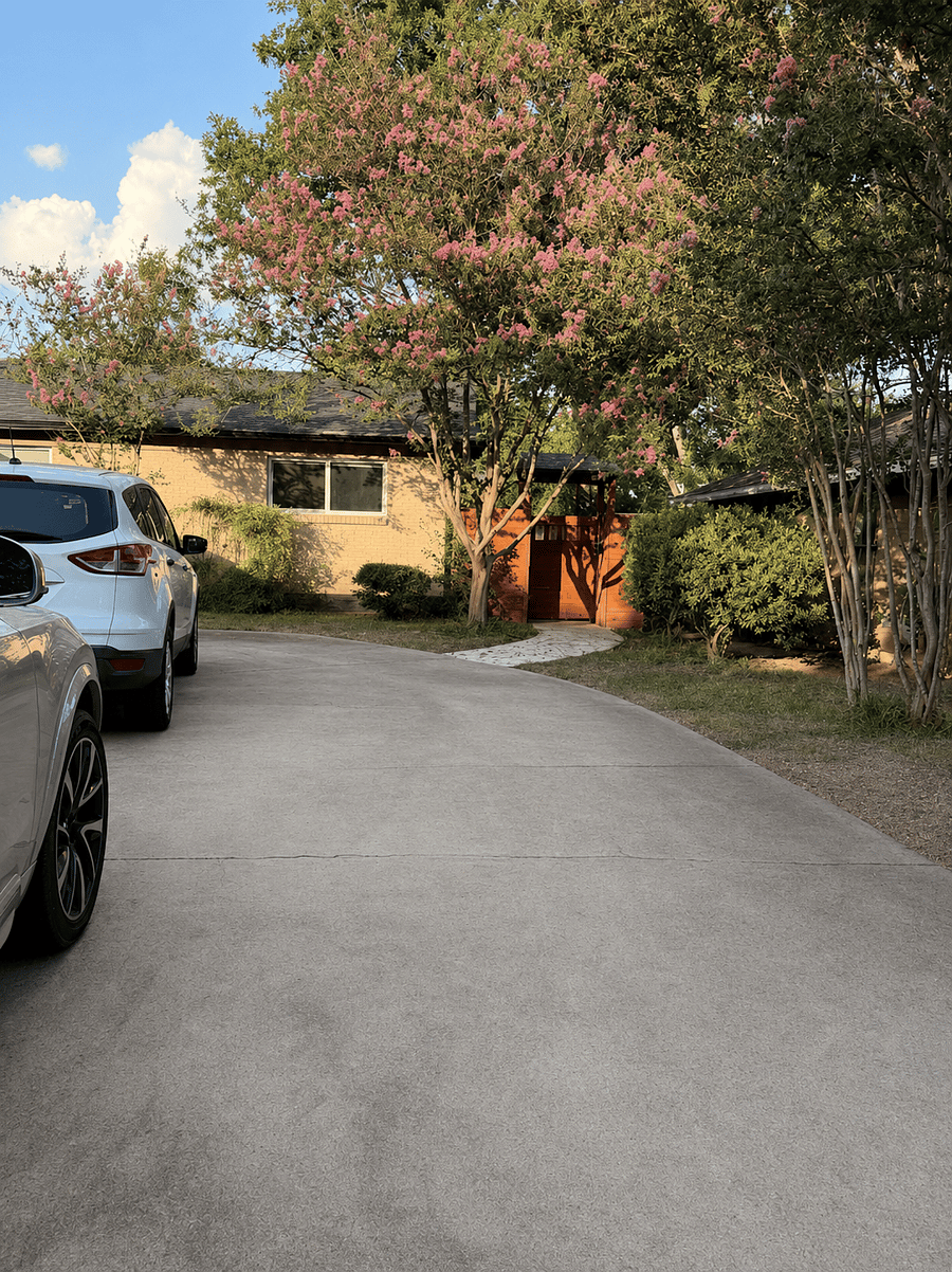 Spacious driveway with walkway leading to the secure coded entry privacy gate.