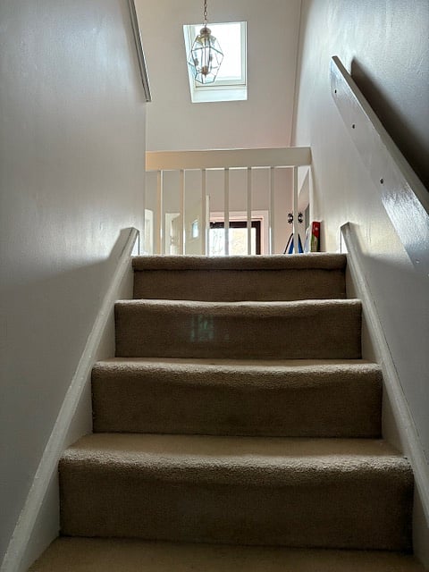 Stairs to second floor where two bedrooms are located.