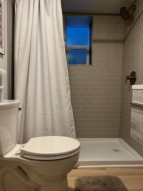 Remodeled basement with one bedroom, seating area and full bath