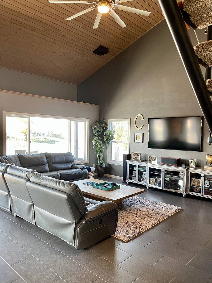 Living room with 87 inch TV.  (the one on the wall showing is not 87 inch) 