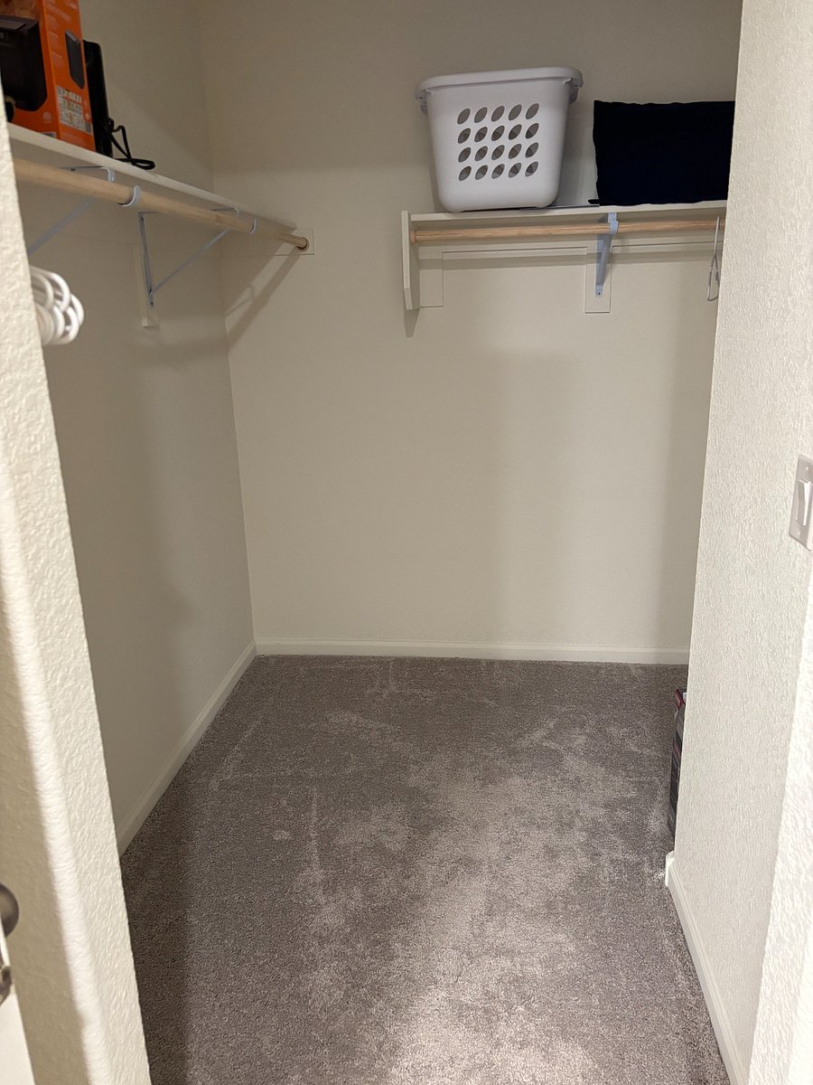 Primary bedroom walk-in closet. Ample storage.