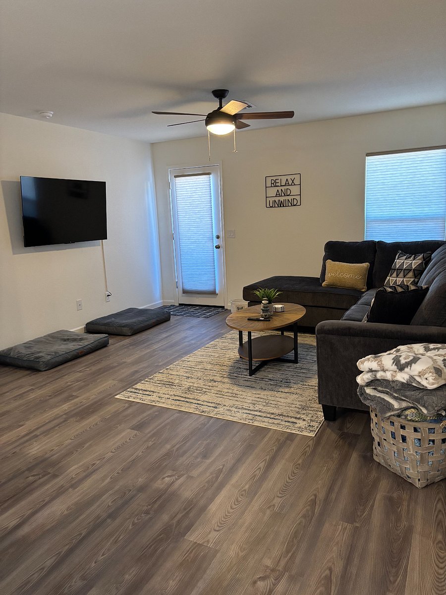 Living room with sectional sofa and Smart TV.