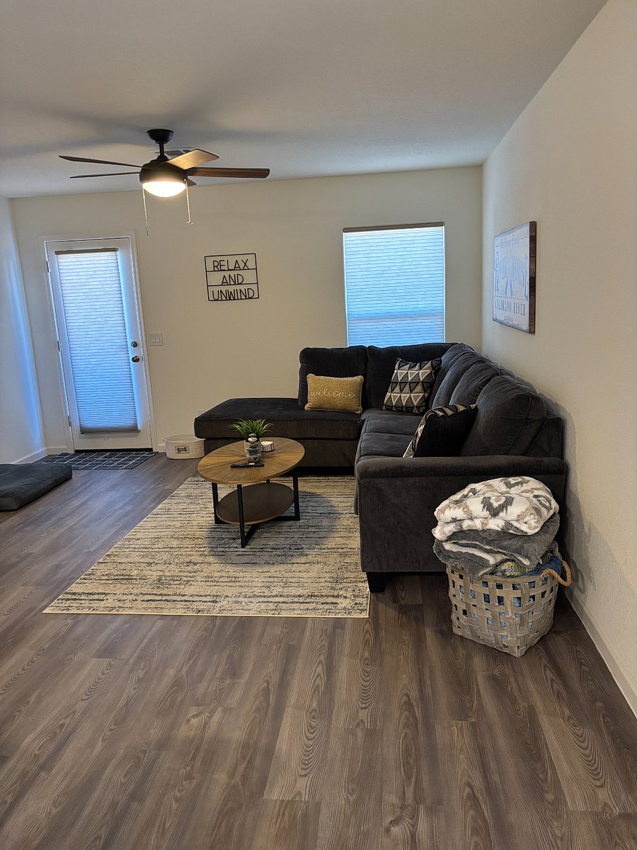 Living room with sectional sofa and Smart TV.