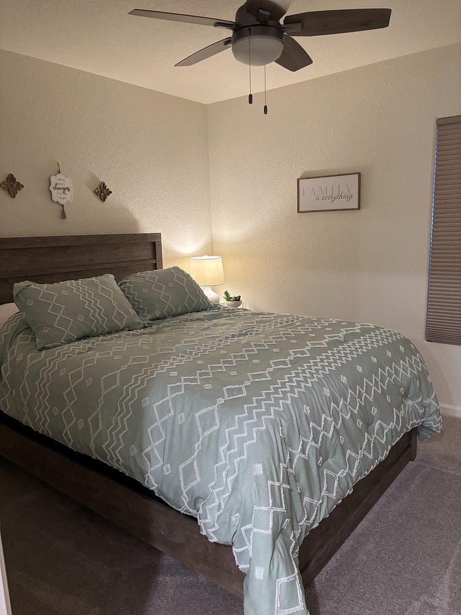 2nd bedroom with Queen bed and one nightstand. Ceiling fan.