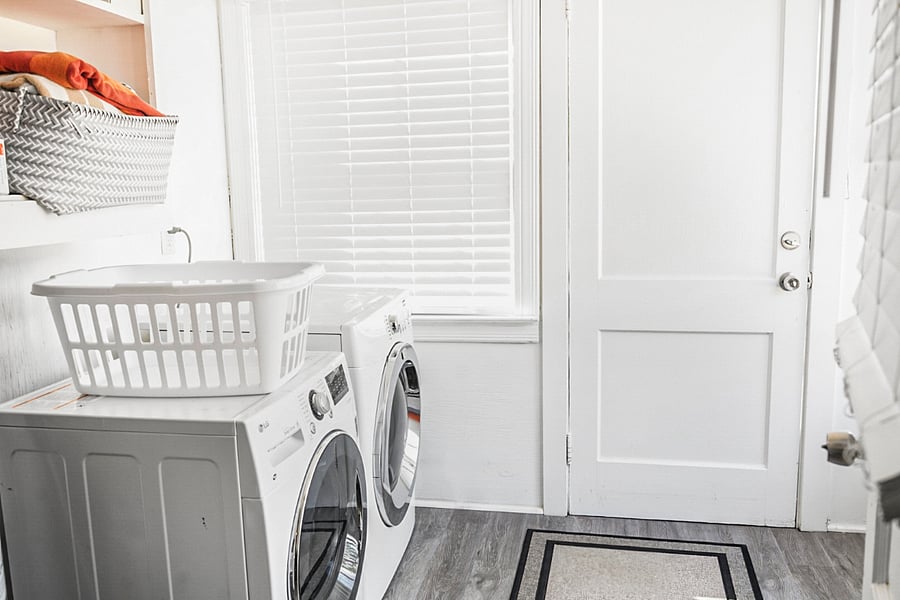 A bright and functional laundry room! Featuring a washer and dryer, ample space, and all the essentials to keep your clothes fresh and clean with ease. 