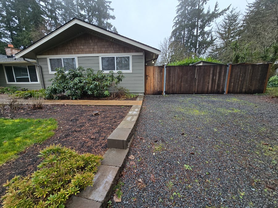 Gravel driveway parking and gate entrance to entry