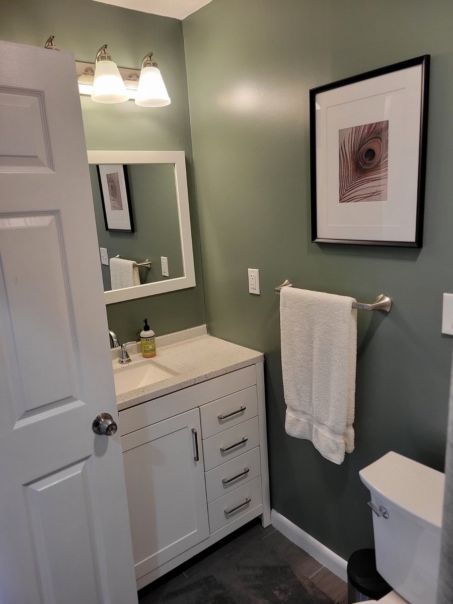 Vanity with storage and towel shelf behind door