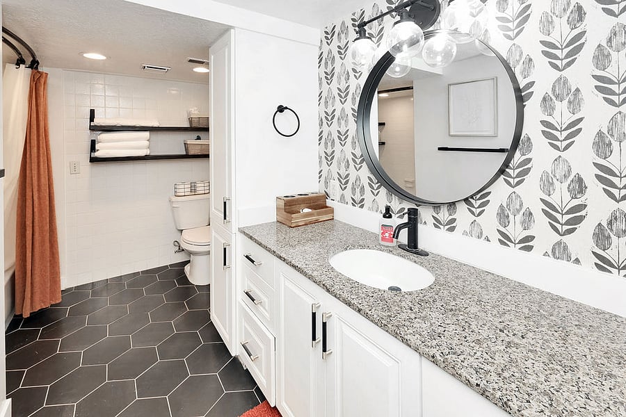 Large bathroom with deep tub with shower. Plentiful cabinet space. We will provide started shampoo, conditioner, and hygiene supplies. Blow dryer. Other hair appliances available upon request. Bath, hand, face towels, floor mats provided.