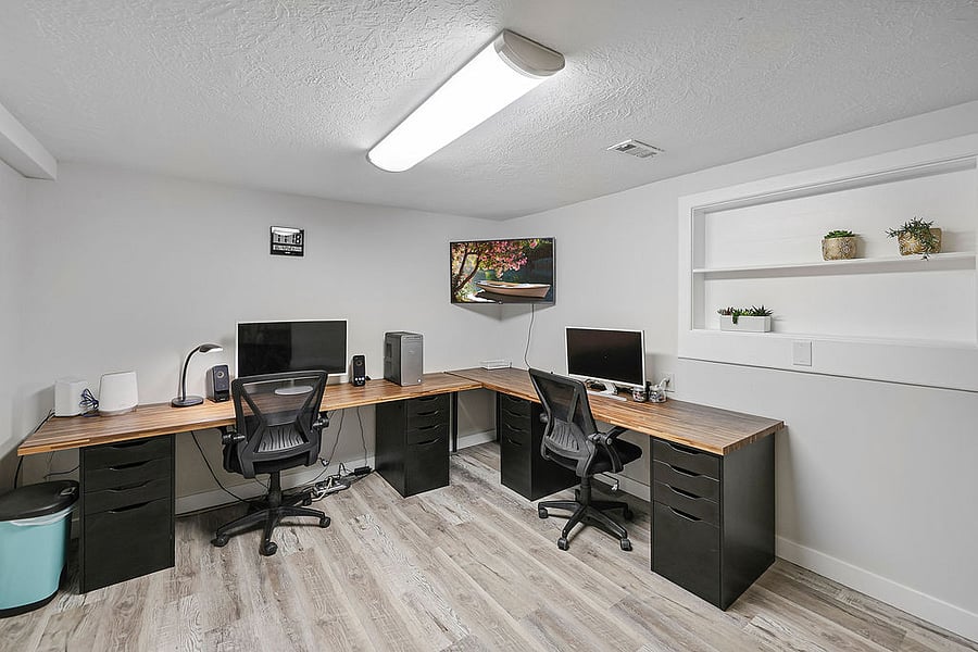 Office space with two work stations. Large monitors, Smart TV and very fast internet ideal for a remote worker or a student. Drawers are empty and available for storing files, or office supplies.