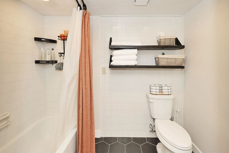 Large bathroom with deep tub with shower. Plentiful cabinet space. We will provide started shampoo, conditioner, and hygiene supplies. Blow dryer. Other hair appliances available upon request. Bath, hand, face towels, floor mats provided.