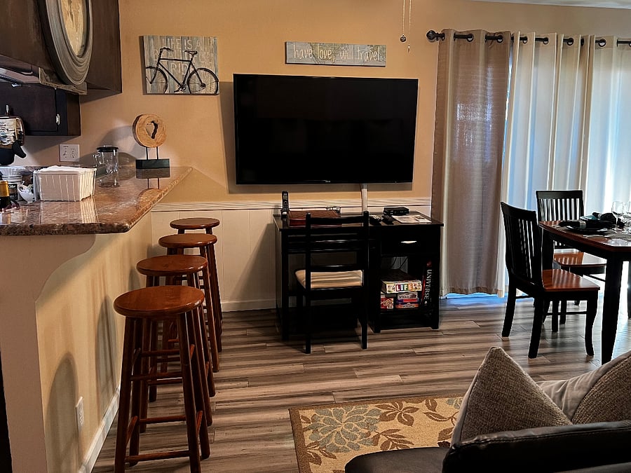 Dining room with granite eating counter and dining table, TV with Dish Satellite