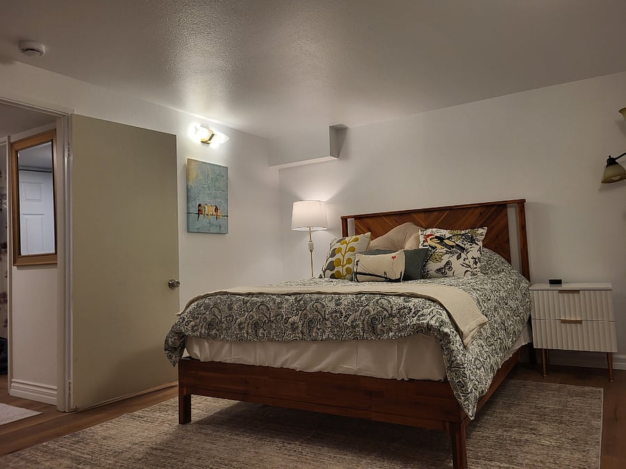 A roomy main bedroom is ready for you to curl up and sleep. (Note: additional artwork and bench have been added; new pictures coming soon.)