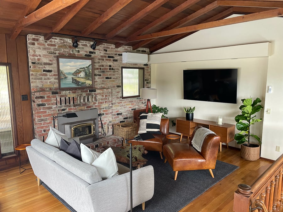Refurnished living room. Beautiful, vaulted, clear heart redwood ceiling and oak hardwood floors.  Wood-burning stove, mini-split, 65" TV, and fabulous views from large picture window of the hills to the south. 