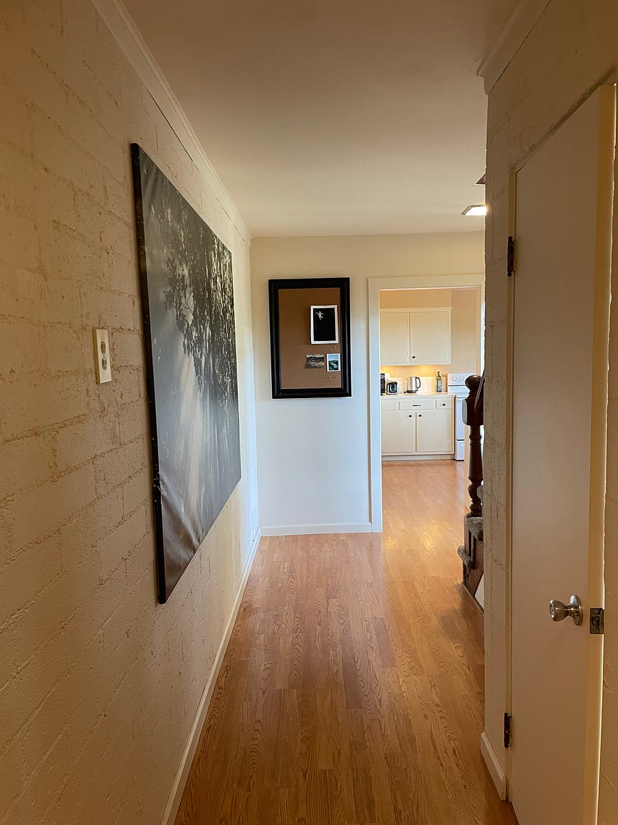 Downstairs hallway with access to lower porch and basement with washer and dryer. 