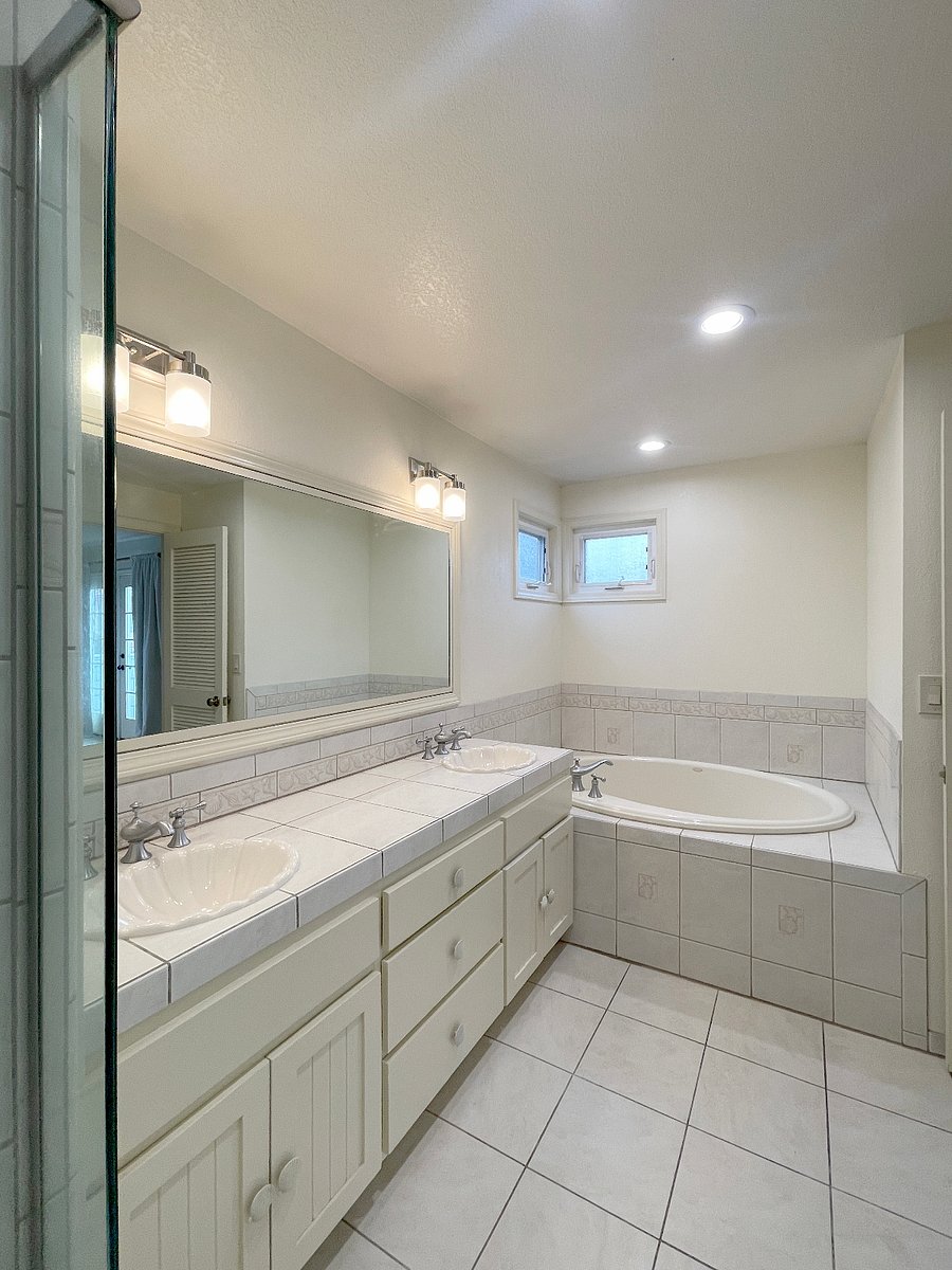 Spacious Primary Bathroom With Double Vanity And Over Sized Soaker Tub