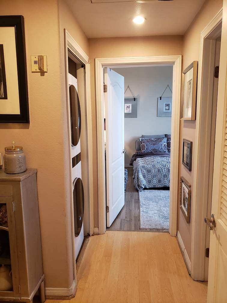 Hallway to bedroom and bath includes washer & dryer area