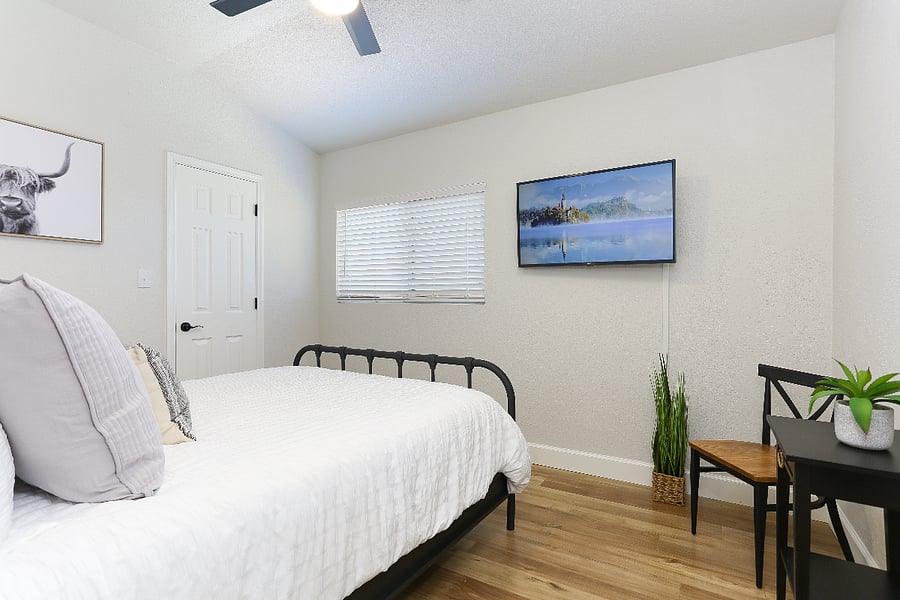 Room #5 upstairs features a cozy queen-sized bed, perfect for restful nights, and a sleek TV for your entertainment needs. Plus, the  fan remote is conveniently placed inside the closet. 