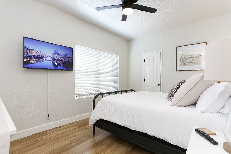Room #2 upstairs features a cozy queen-sized bed, perfect for restful nights, and a sleek TV for your entertainment needs. Plus, the  fan remote is conveniently placed inside the closet. 
