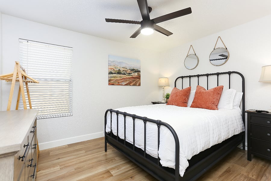 Room #1 downstairs features a comfortable queen-size bed and a mounted smart TV for your entertainment. 