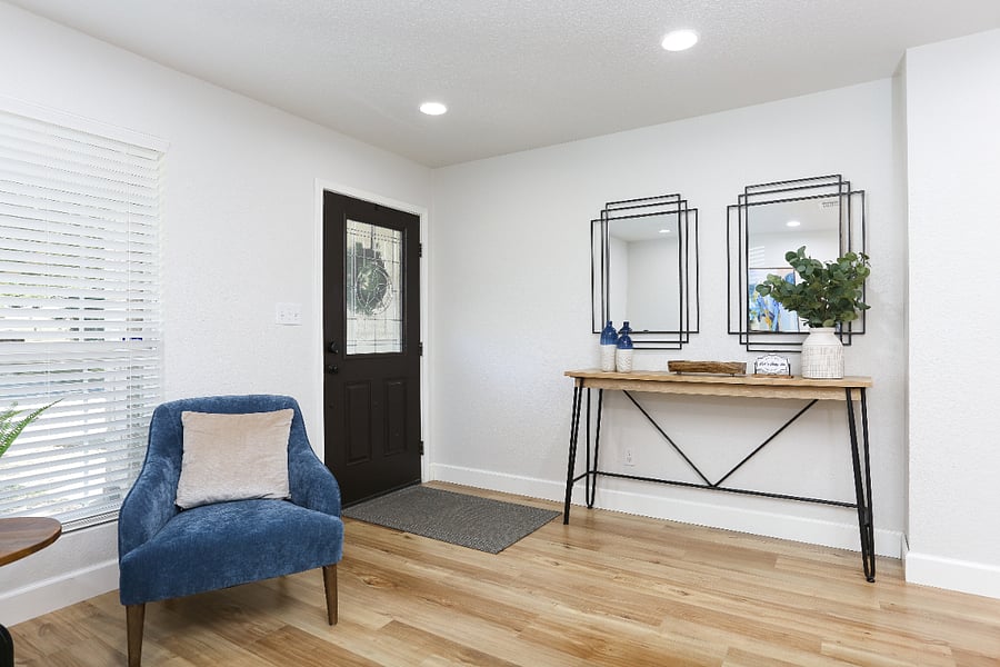 This is the entrance of the house, simple and welcoming. Right on top of the entry table, we'll place the house keys in a small tray or key holder.