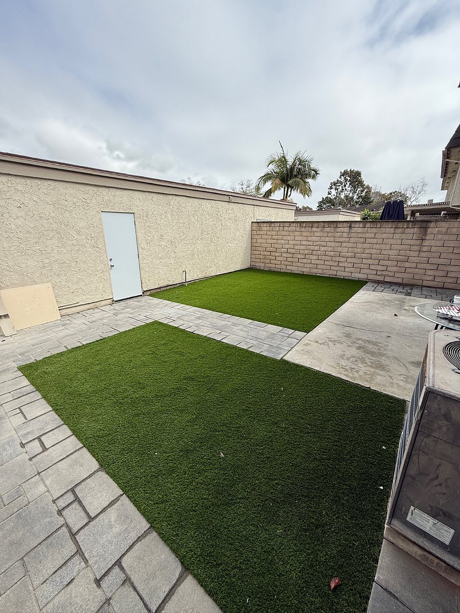 Backyard area between two car garage and house.  