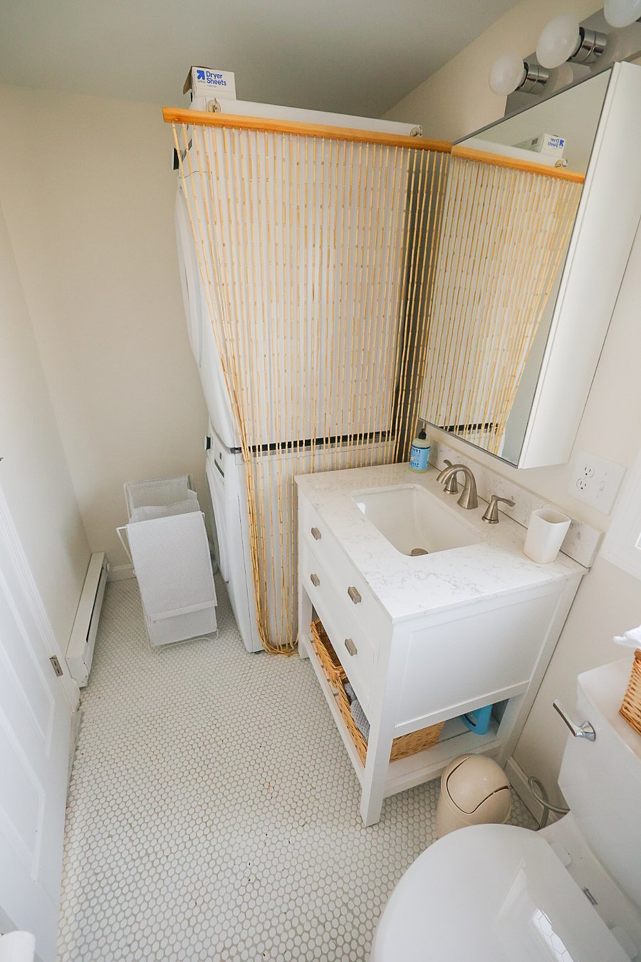 The washer and dryer are located behind the bathroom door.