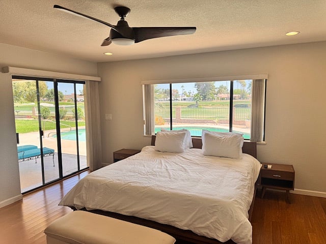 The master bedroom features a king sized bed and is equipped with lots of light and a sliding door leading to the breathtaking views of the pool and golf course. 