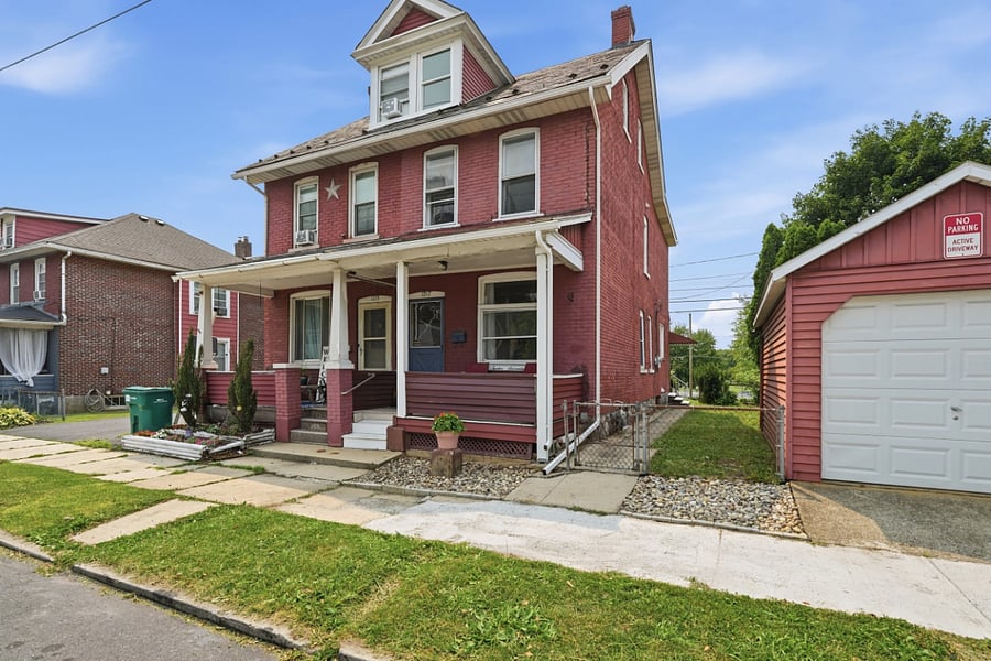 Exterior photo of the brick house and garage
