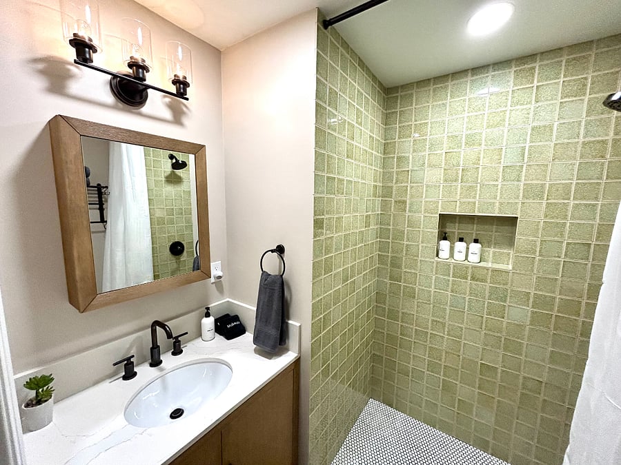 The designer tile and fixtures make the hallway's second bathroom feel like a sanctuary.