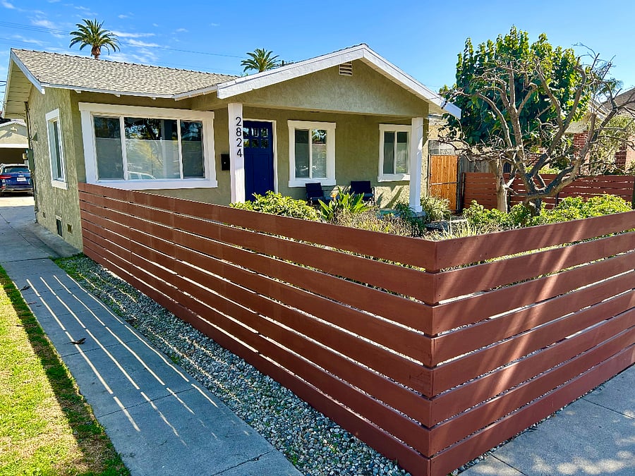 The landscaped front yard is completely fenced and gated.