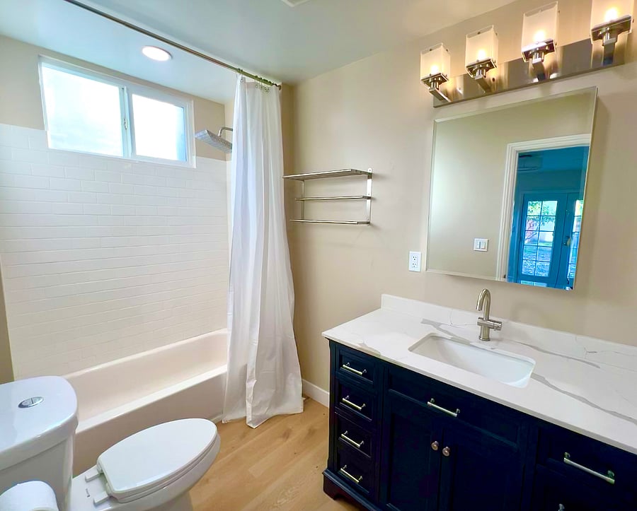 The king ensuite bathroom has a tub, rain shower head, bidet seat, and lots of storage space for your personal effects.