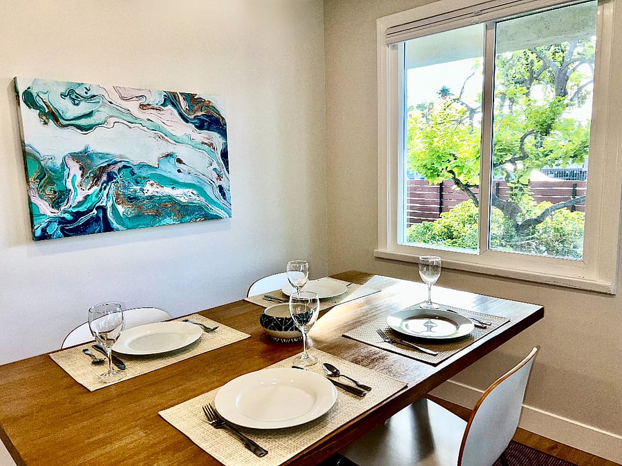Enjoy green front yard views from the West Elm dining table.