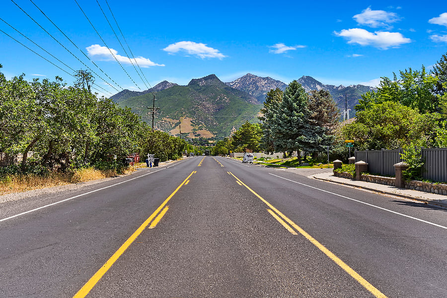 Quiet road leads up to mountains and trails