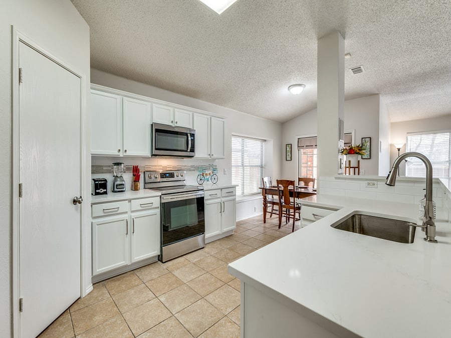 Full kitchen with new countertops and tile backsplash