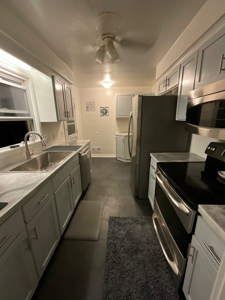 Italian porcelain tile, farmhouse sink, custom counters, dishwasher, fridge, stove, air fryer, and coffeemaker