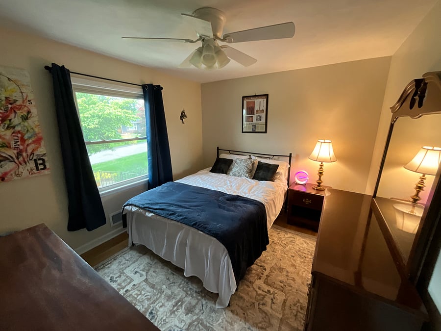 Executive bedroom with 45 Samsung Firestick TV, plush carpet & pad for comfy, barefoot walking, beanbag chair for ultimate lounging, sunrise alarm clock with wireless phone charger