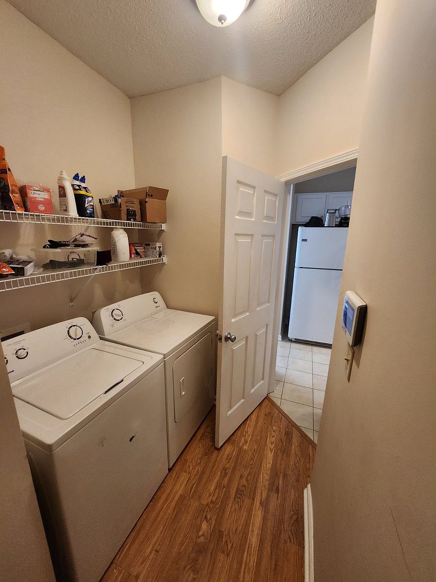Laundry room next to the kitchen and the garage.