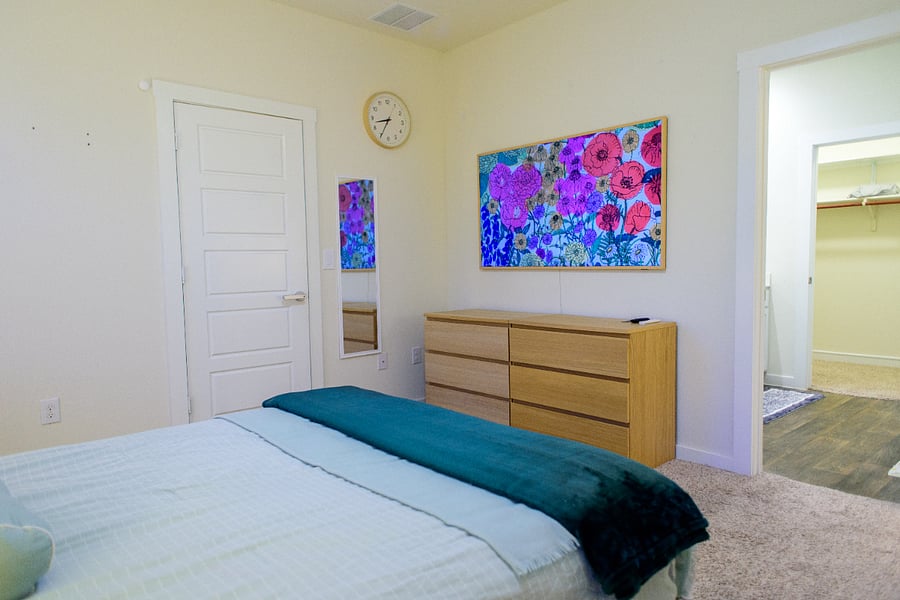 Spacious wood dresser for easy unpacking, with the private bath just through the door.