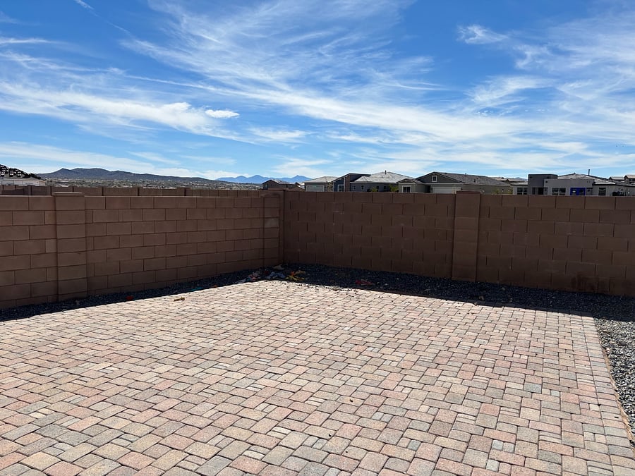 Brick fenced backyard with separate dog run.