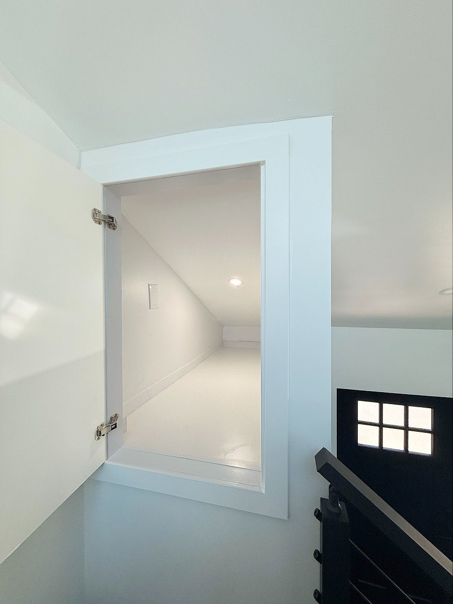 Additional storage space above closet is accessed at the top of the stairs.