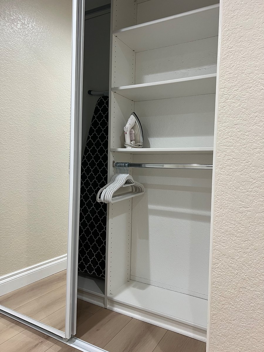 Closet with Ironing Board, Iron, and Hangers