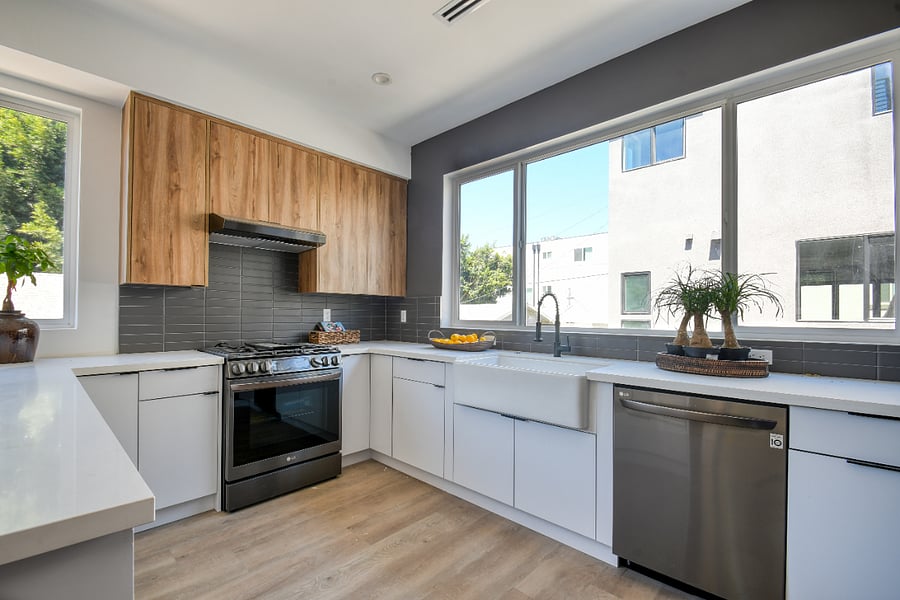 modern kitchen with gas stove, dishwasher, microwave and walk-in pantry