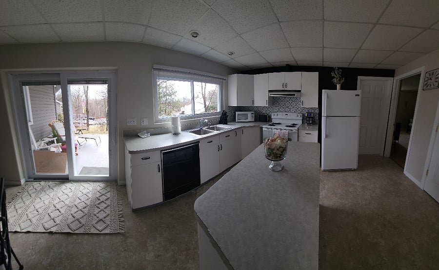 Well-lit kitchen open to dining area and living room