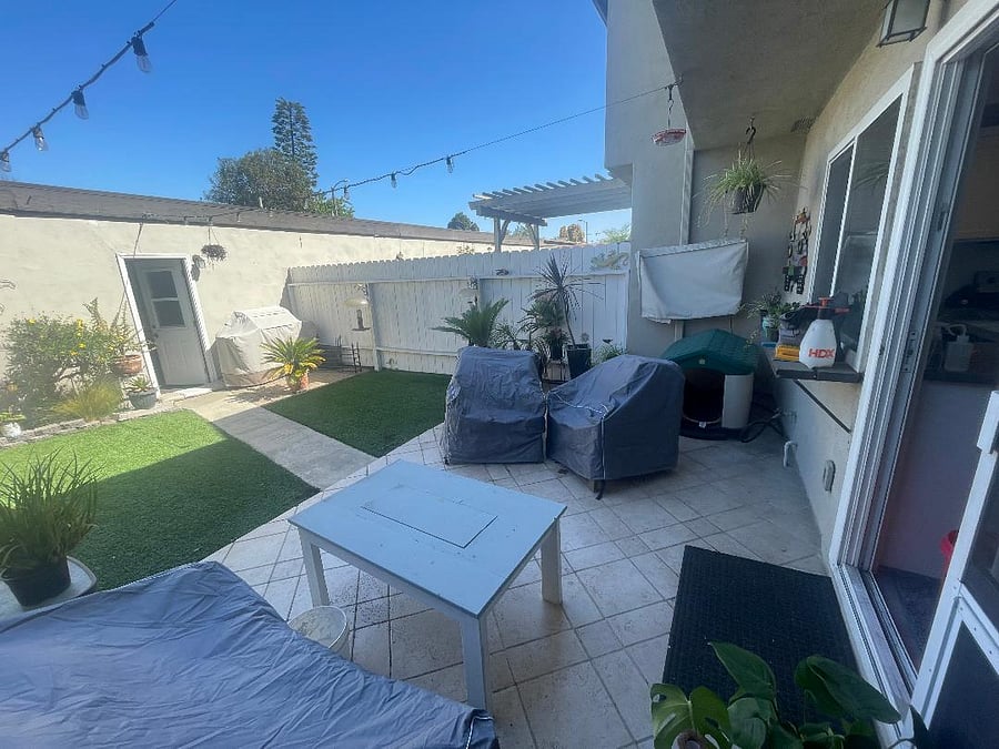 back patio with seating area and TV.  Detached garage with washer/dryer