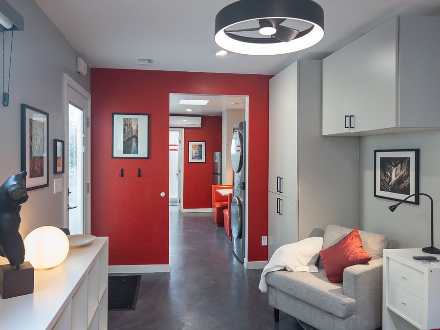 Living Space with Ceiling fan, Builtin Storage and Armoire Closet, Book Cases, Night Stand, Armchair, reading lights, Clothing Hooks.
Photographs of the owner's world travels.
Space leads into Kitchen Space.