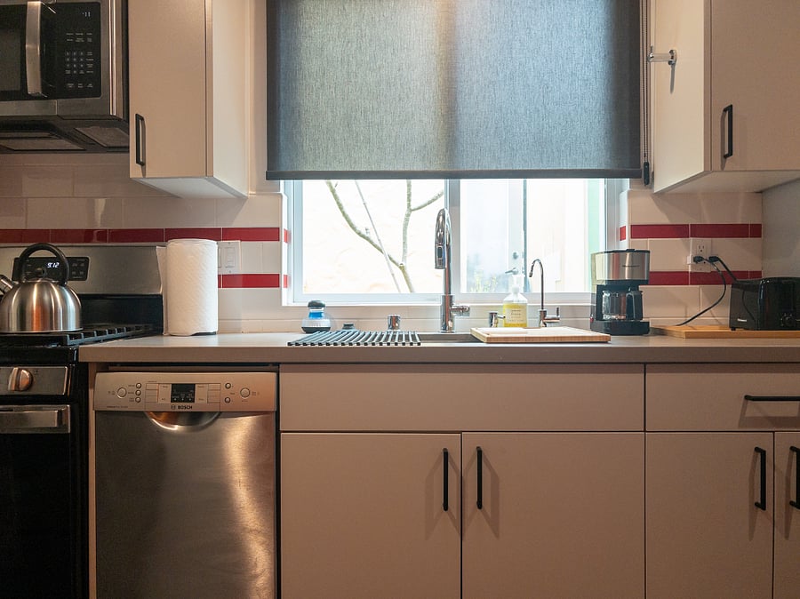 Kitchen Cabinets, Full-Sized Deep Stainless Steel Sink with Drying rack and Cutting Board, Coffeemaker, and Toaster.
Compact Stainless Steel Bosch Dishwasher.
Reverse Osmosis filtered drinking water tap.