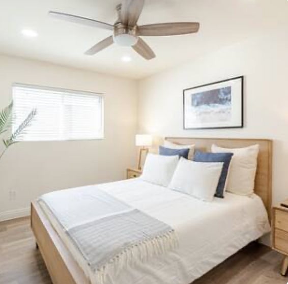 Middle bedroom - queen bed with two nightstands, closet, and ceiling fan.