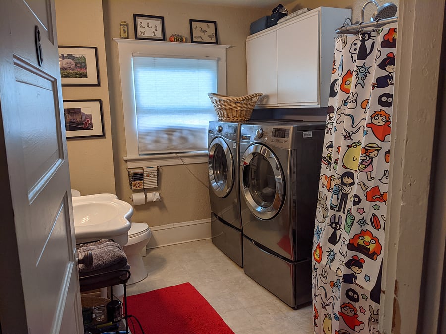 Shared bathroom across the hall with washer/dryer and a clawfoot tub