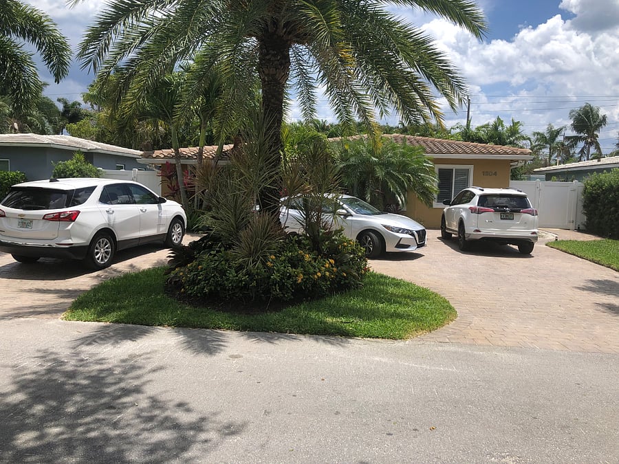 Property front yard providing ample parking and the entrance to the suite through the gate on the left